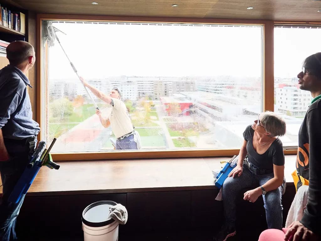 A professional squeegee stroke on a large window, soap water being drawn cleanly off the glass