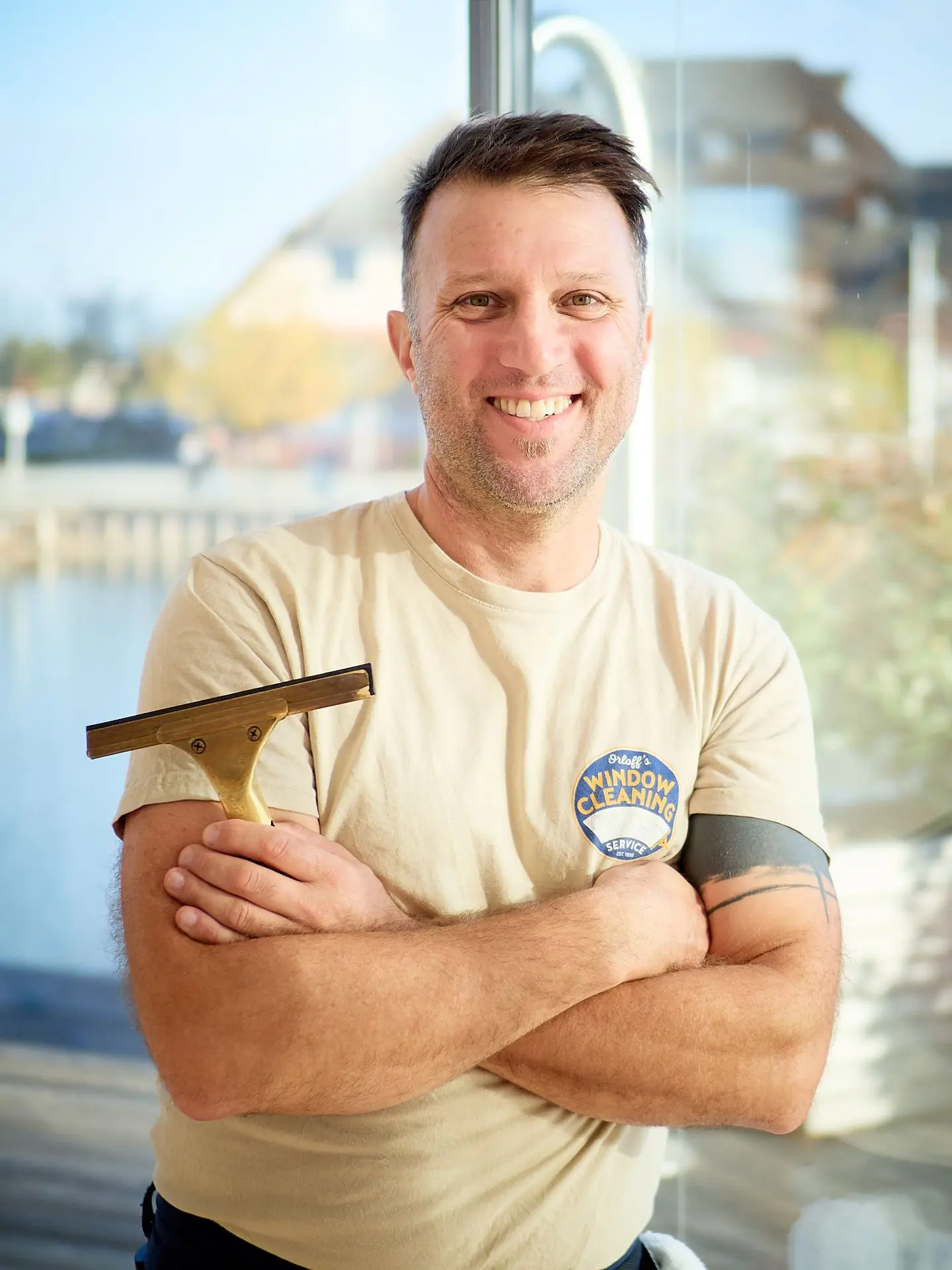 Justin Orloff during a professional window cleaning tutorial, applying 25 years of hands-on technique